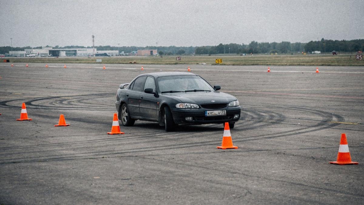 Test car braking hard between cones on a dry airfield runway